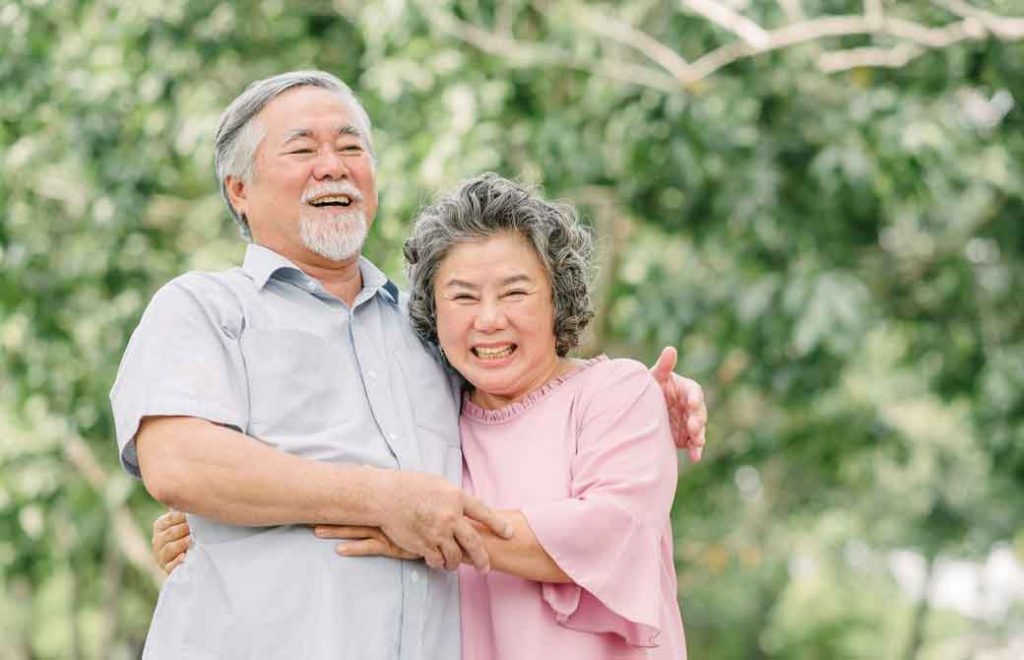 笑顔でハグをしている老夫婦