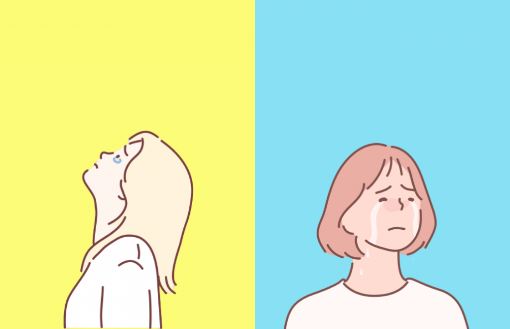 泣くのを我慢する女性と、泣く女性